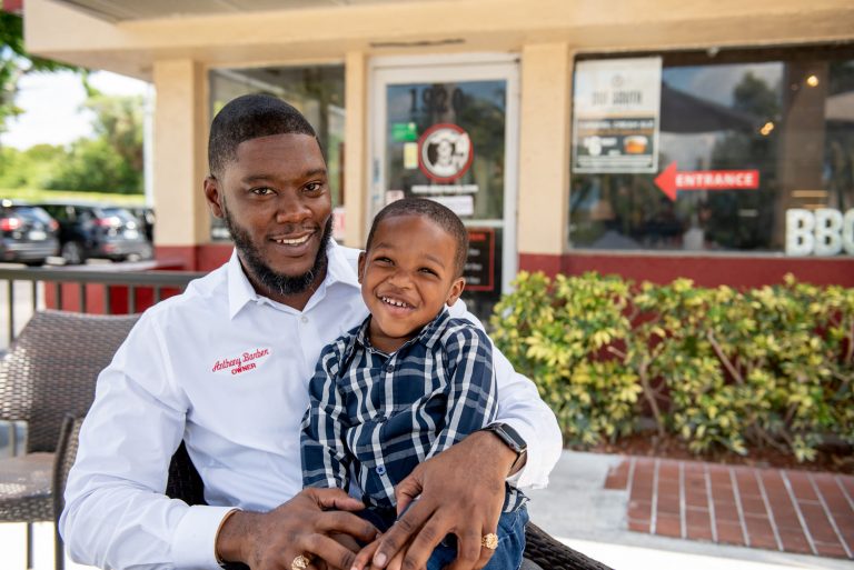 Anthony Barber at Troy's Barbeque with his son