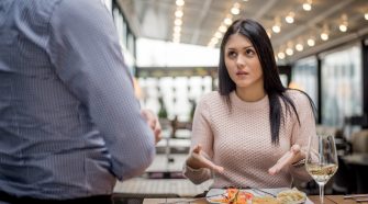 Portrait of woman complaining about food quality and taste in restaurant.