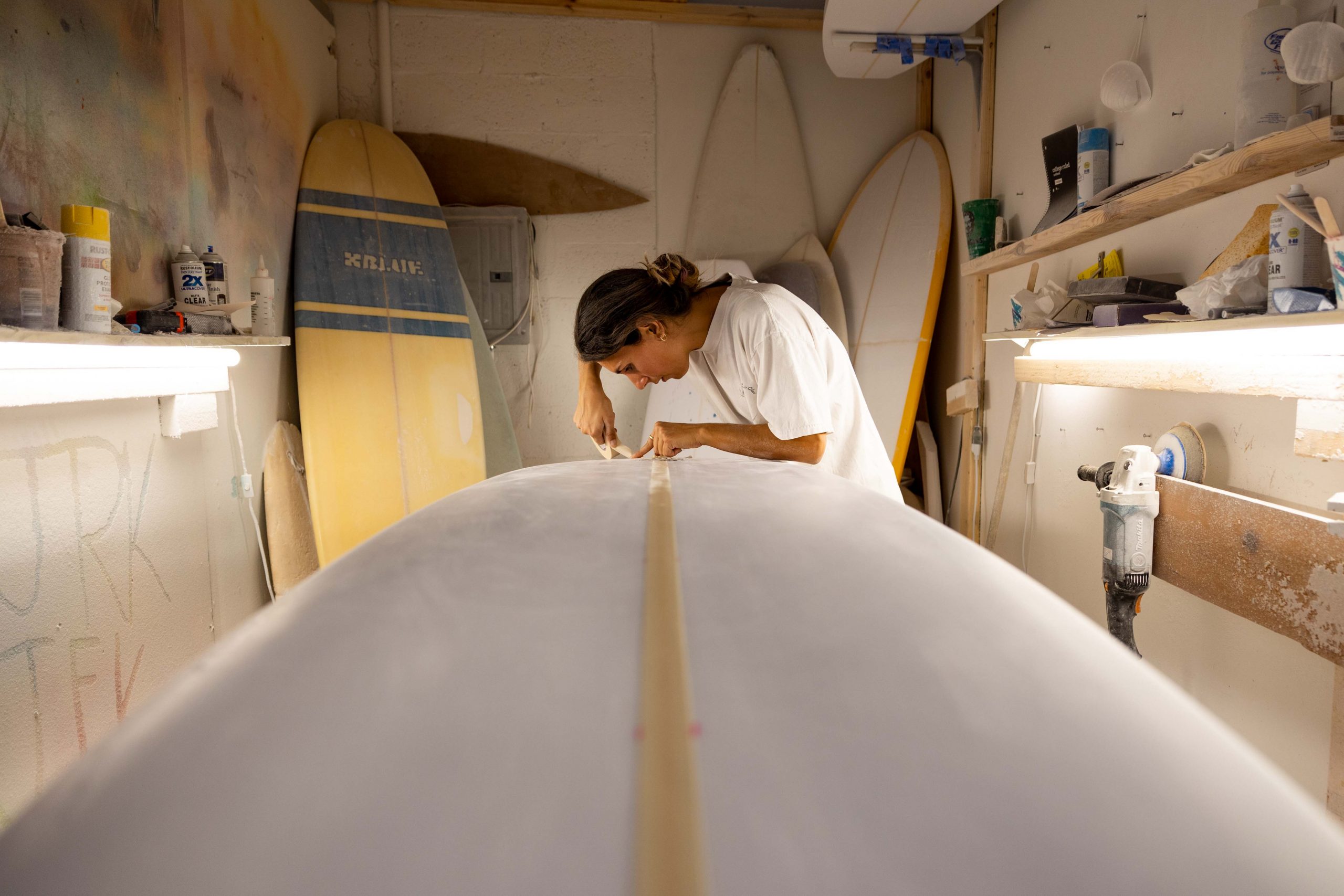 Catherine Girard shapes surfboard in Boca Raton