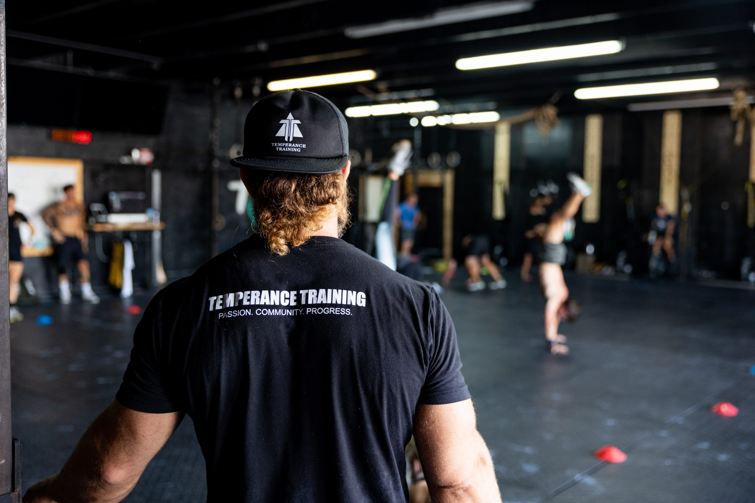 Temperance Training owner, Anthony Fazio faces away from the camera during a CrossFit class.