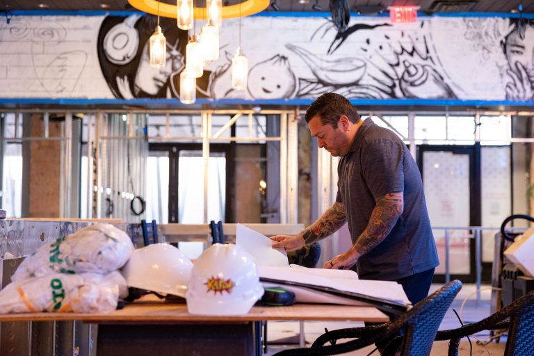 Vaughan Dugan, founder of Boca restaurant, Kapow!, looks over plans.