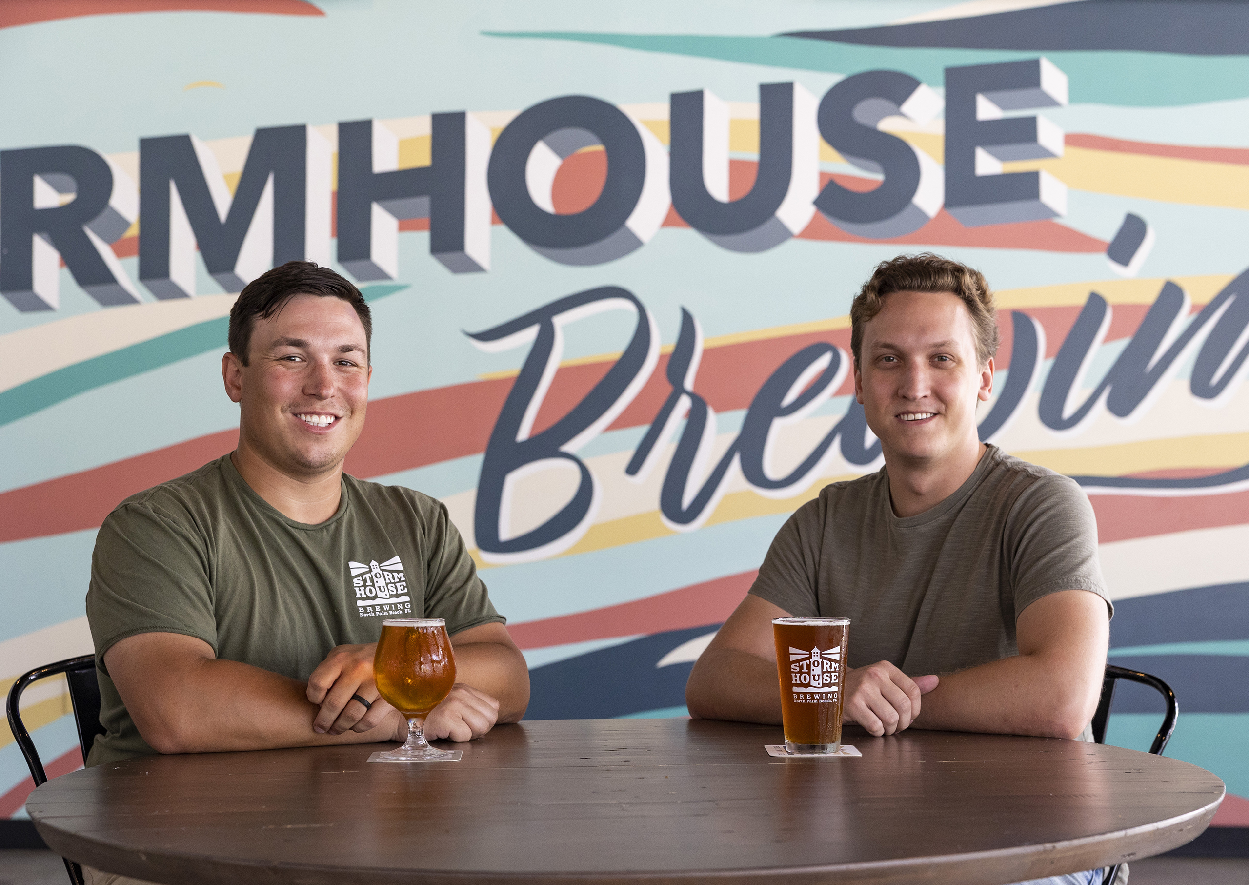 Brothers and Stormhouse Brewing owners Josh and Christian Brinzo pictured in front of a mural at their brewery in North Palm Beach, FL.
