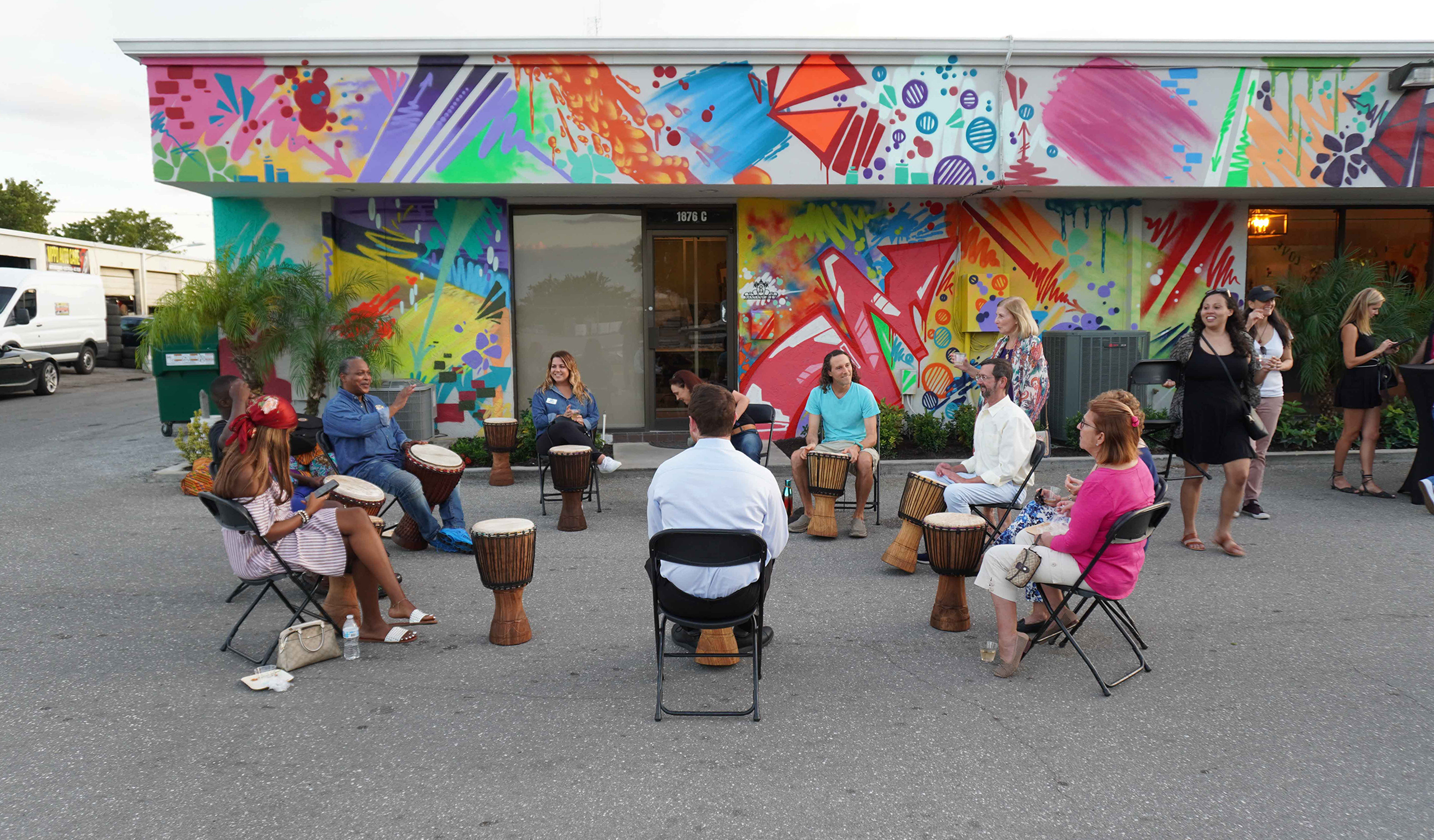 Drum circle outside colorful mural in Delray Beach at Andre Design District.