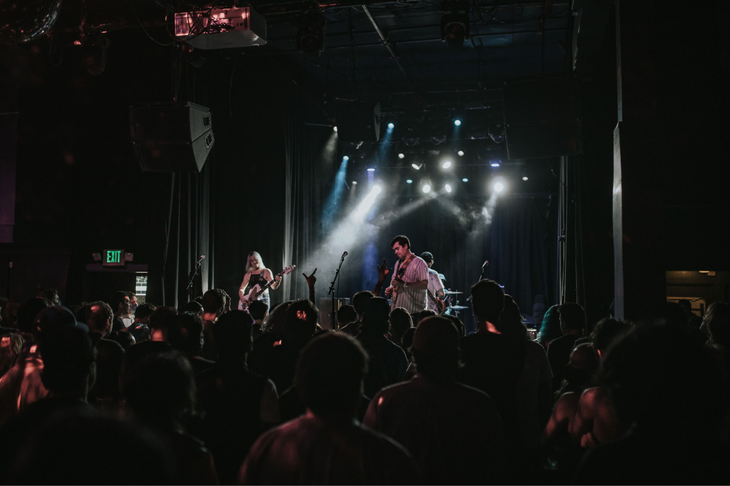 Wide angle shot of Surfer Blood performing live for large crowd.