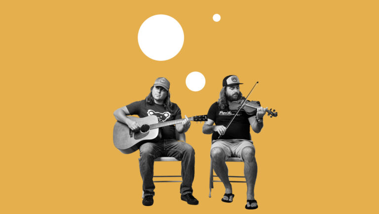 The Brians of Uproot Hootenanny sitting in front of a white backdrop sheet with their instruments.