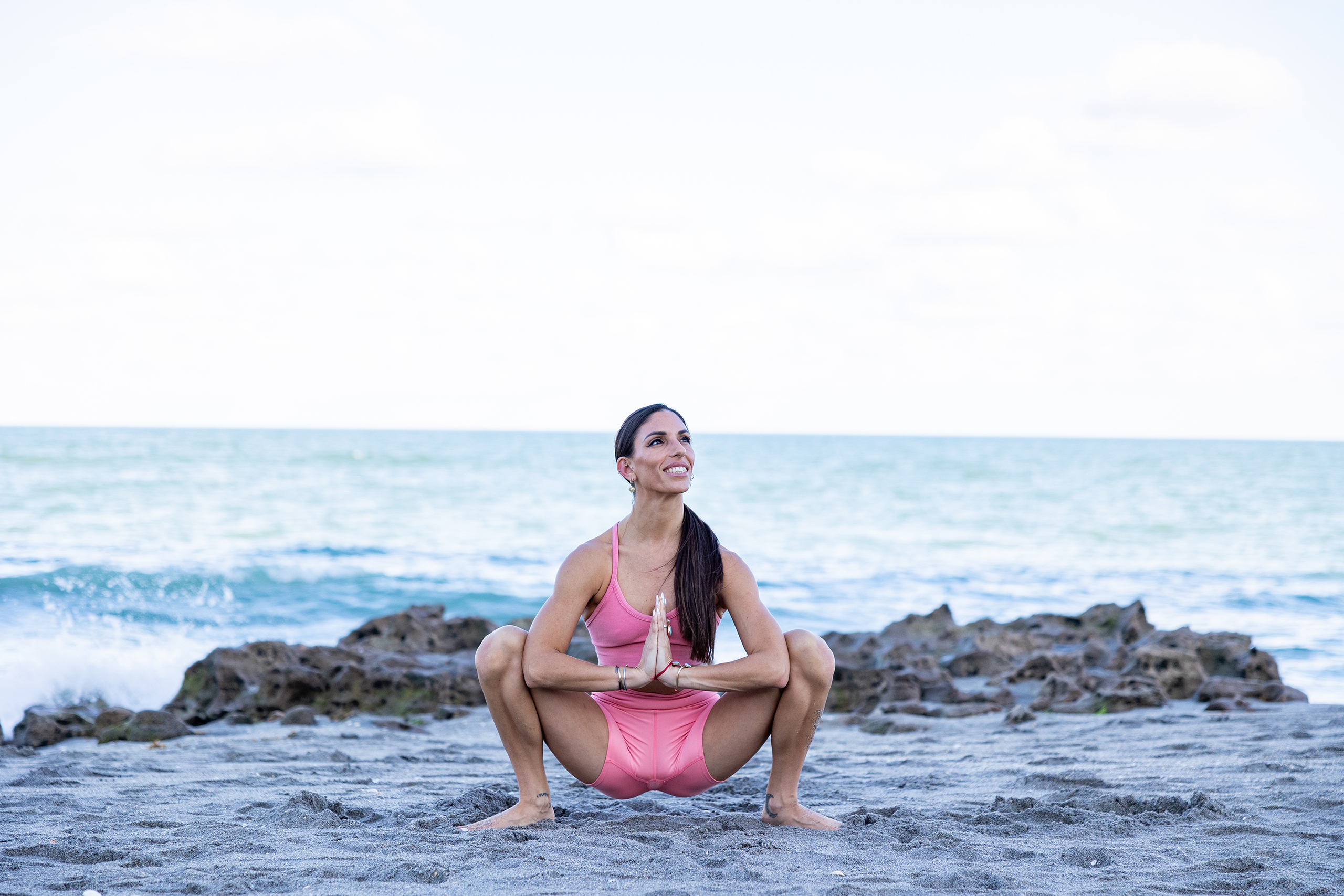 couple practising yoga poses sitting on beach by sea Stock Photo - Alamy