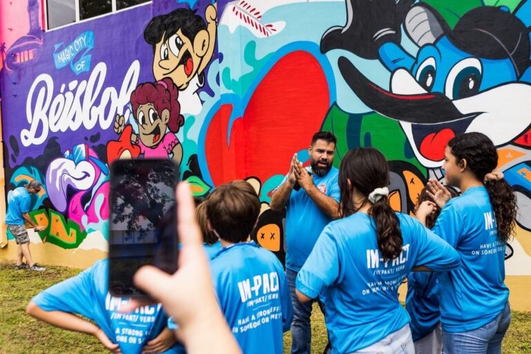 Surge x Marlins at the Boys and Girls Club Miami in front of his freshly painted mural.