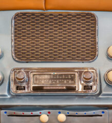 Road Trip playlist. Old chrome car radio with speaker inside a classic American car