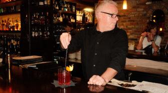 Brett Hart, bartenders at Okeechobee Steakhouse, stirring a cocktail.