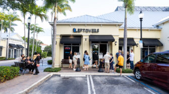 A line of people forms out of the front door and onto the sidewalk of Leftovers Cafe in Jupiter. Leftover's is dog friendly in the outside seating section.