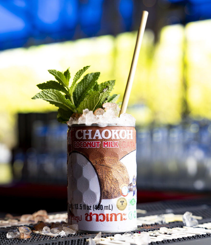 The Throat mocktail at Kapow! served in a coconut milk can with a mint sprig as a garnish. 