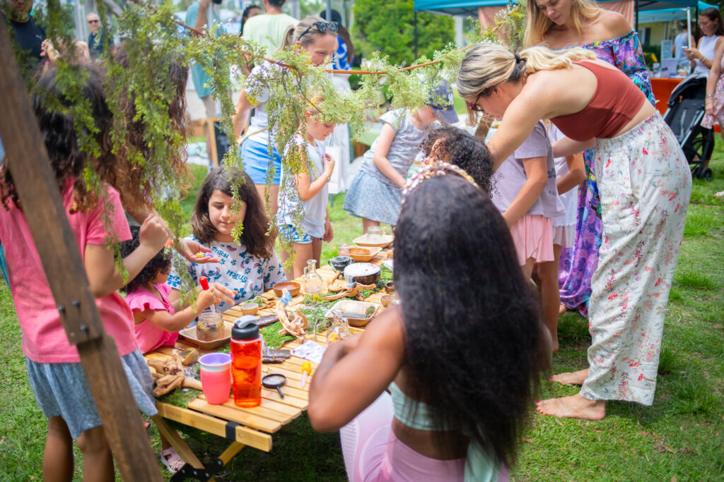 Children gathered around a craft table at Coco Market in Delray Beach. 