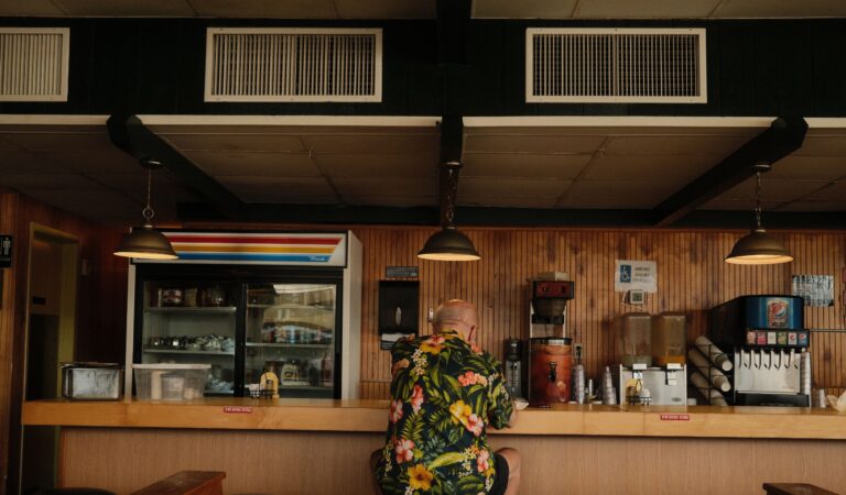 Sande's Diner in Delray Beach. Man in tropical print shirt sits at a diner counter.