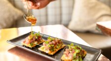 Close-up of Chef Clay Conley plating dishes at Buccan in Palm Beach.