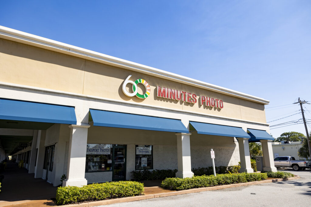 The exterior view of 60 Minutes Photo in Jupiter with a blue sky.