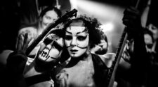 Band members of Daikaiju in masks in black and white inside Respectable Street bar in West Palm Beach.